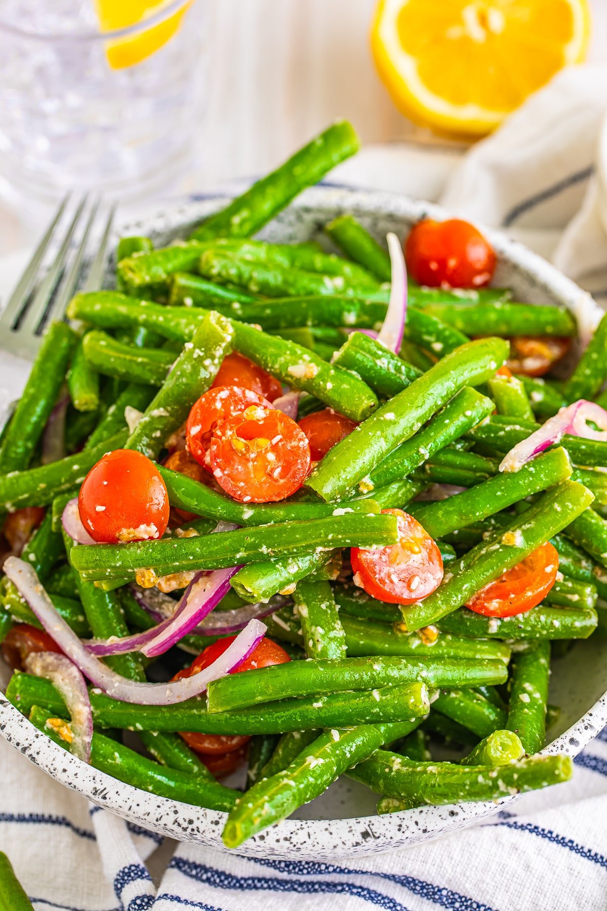 Cold green bean salad in a speckled bowl, close up