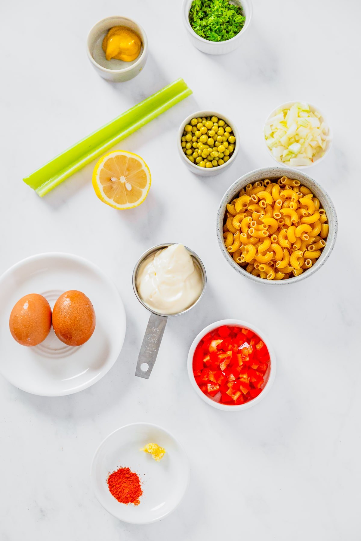 Overhead image of ingredients needed to make macaroni salad with peas
