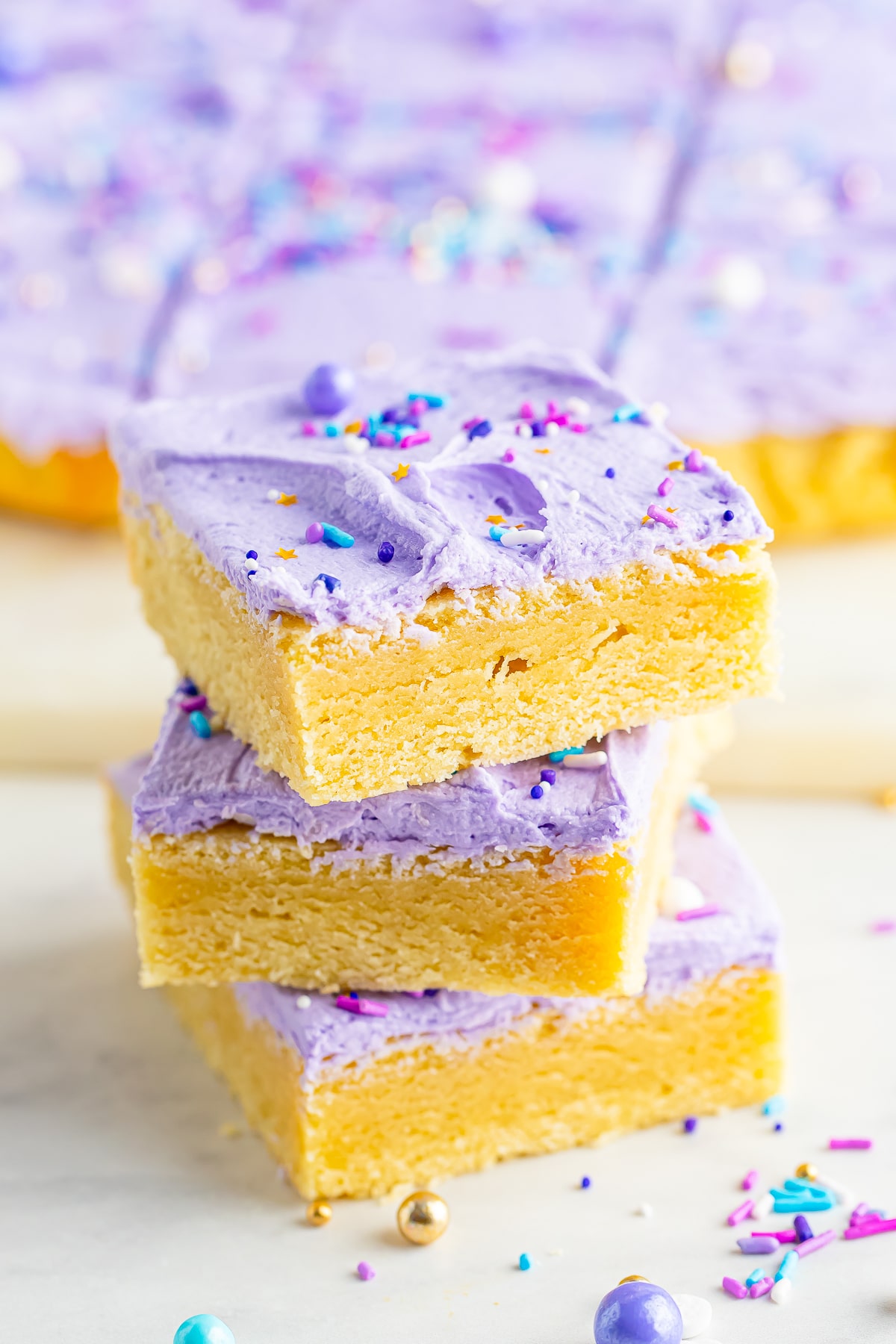 A stack of frosted sugar cookie bars