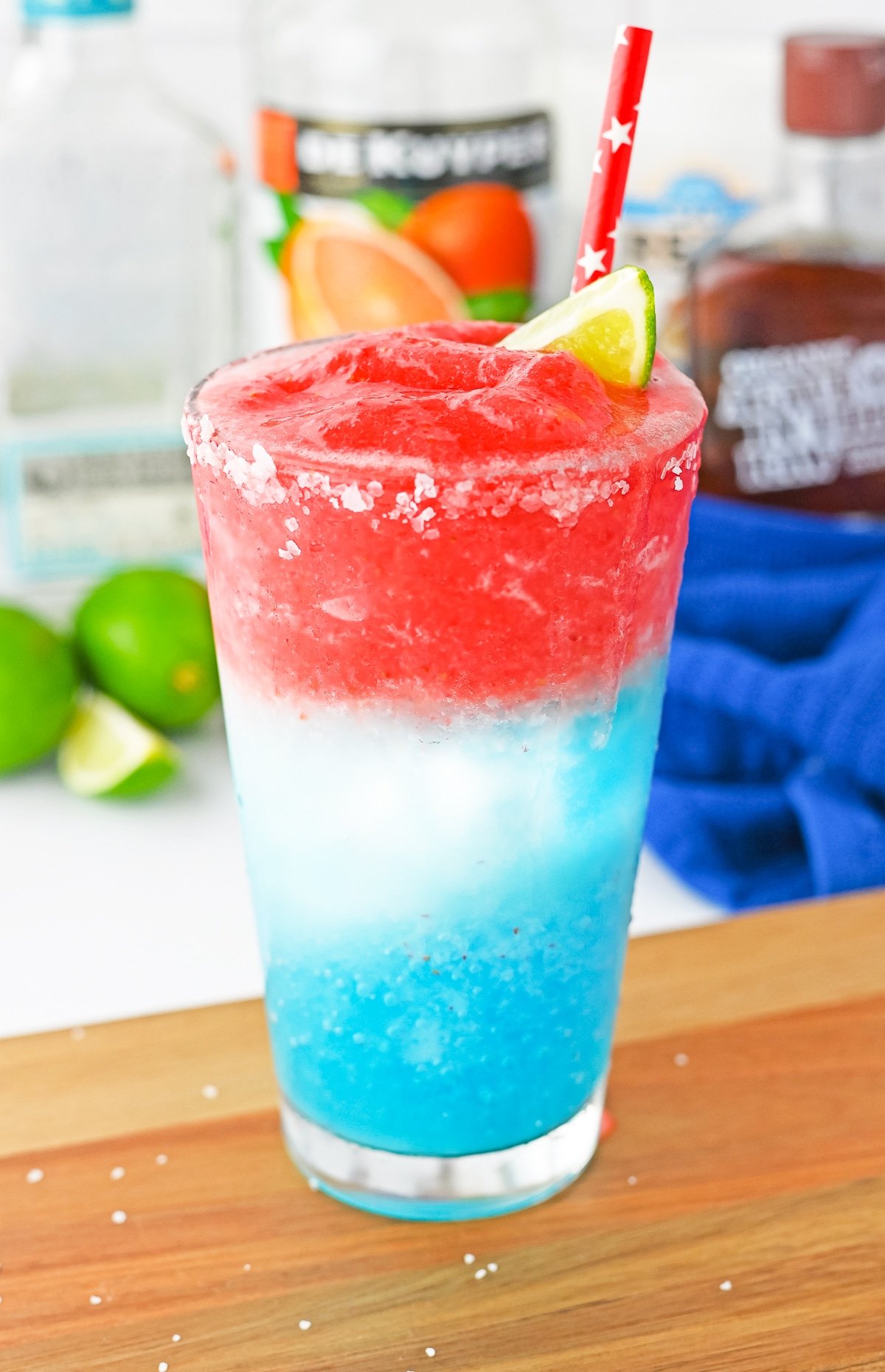 red white and blue cocktail on a wooden board