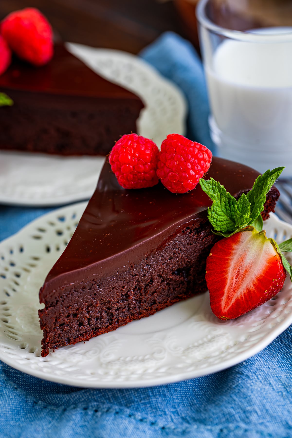 slice of flourless chocolate cake recipe on a ivory plate