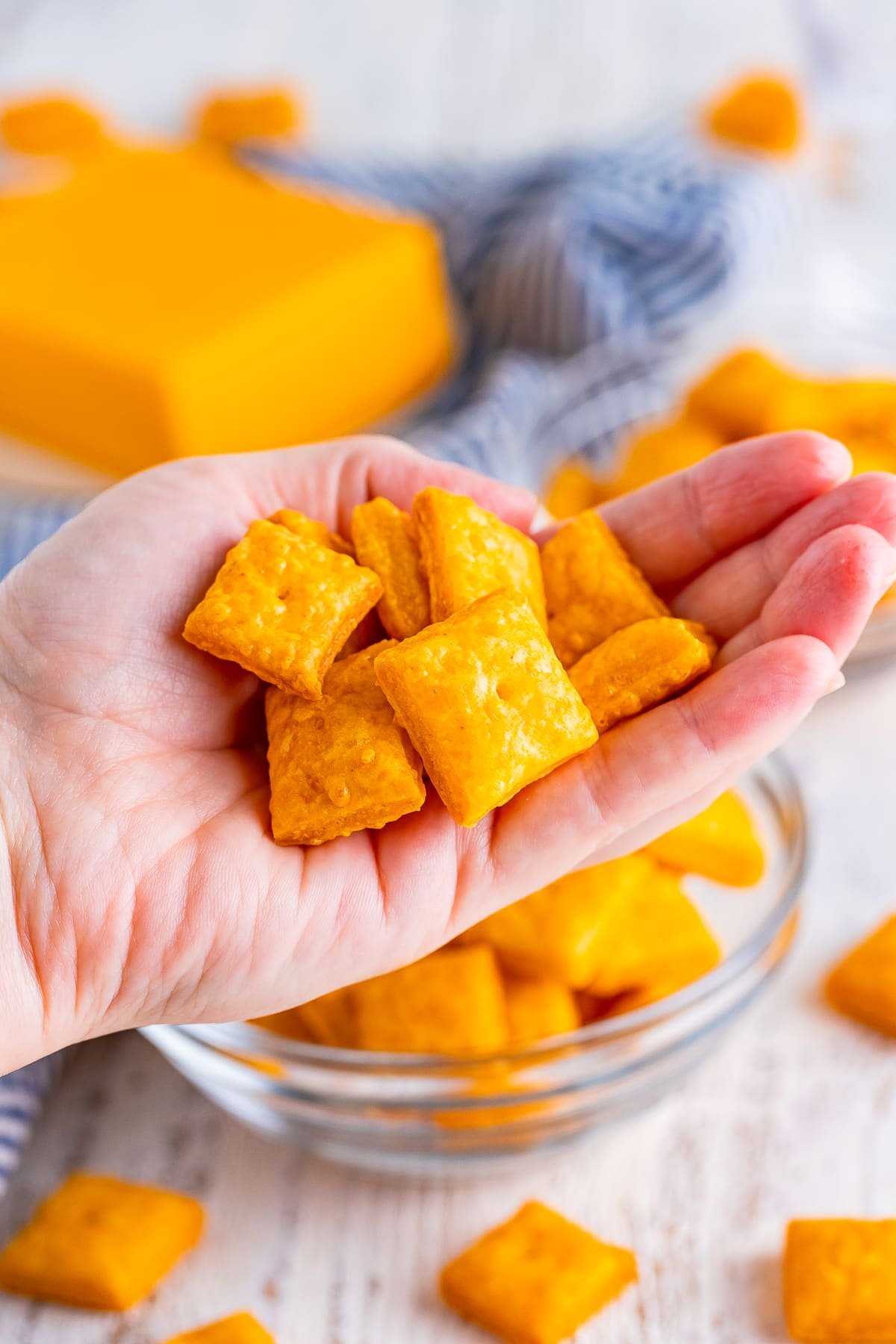 a hand holding up a handful of homemade cheez its