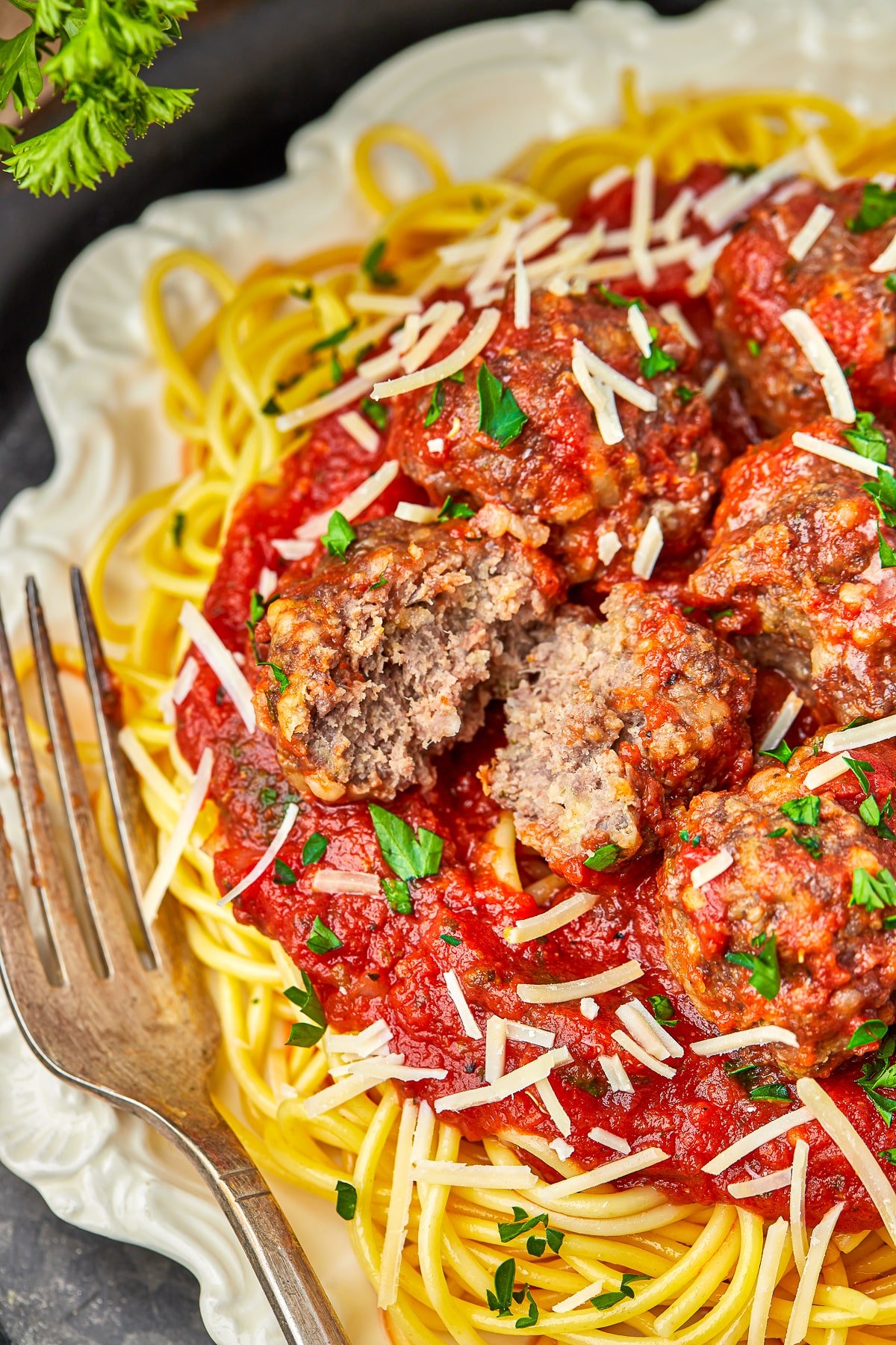 baked meatballs with spaghetti on a white plate