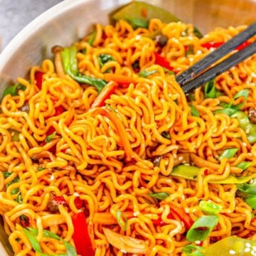 Chow Mein with Ramen Noodles tossed with vegetables in a savory sauce in a bowl with chopsticks.