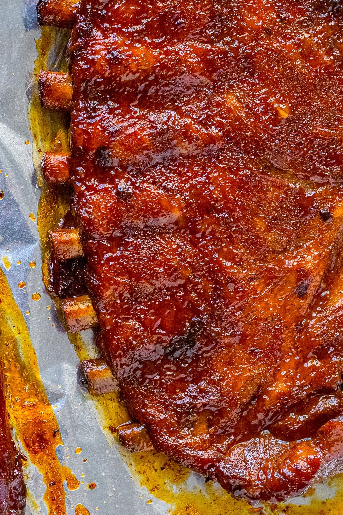 up close image of ribs in slow cooker on a piece of foil