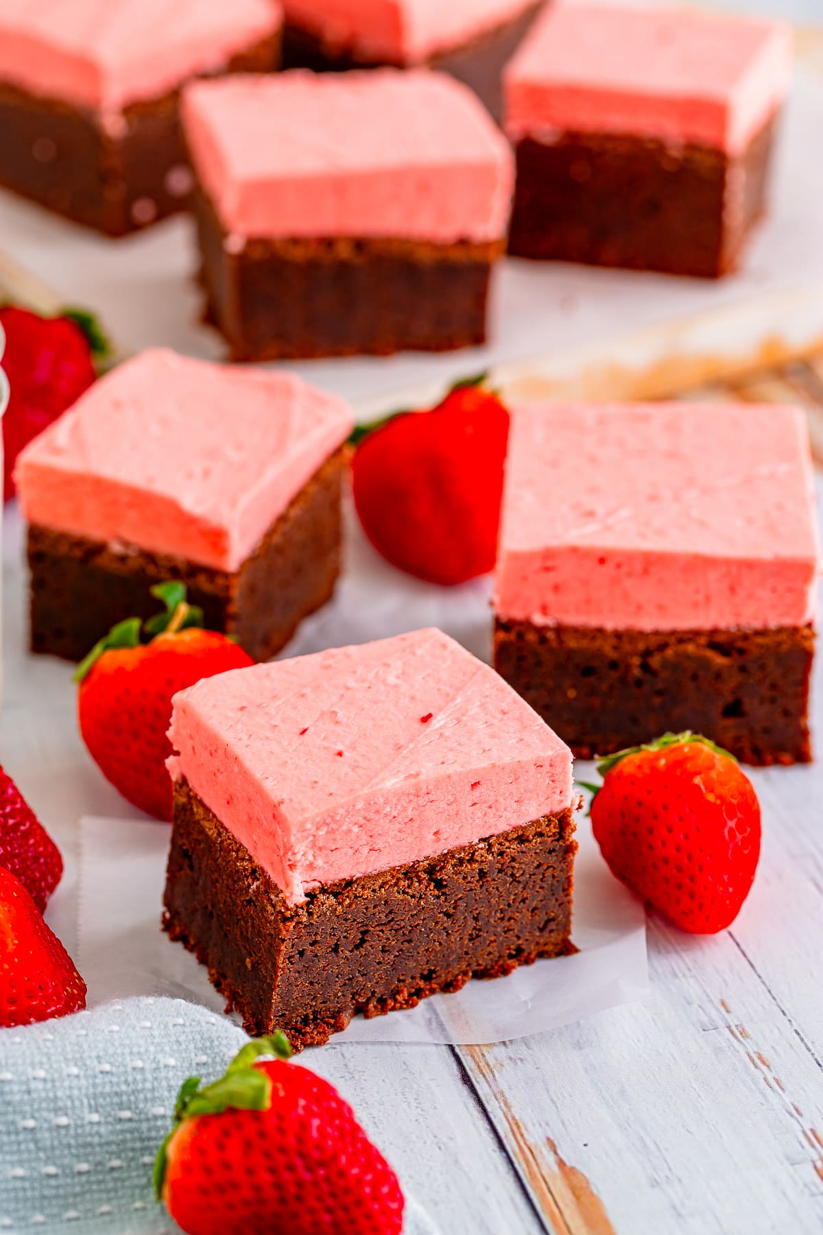 BROWNIE WITH STRAWBERRY FROSTING ON PARCHMENT PAPER