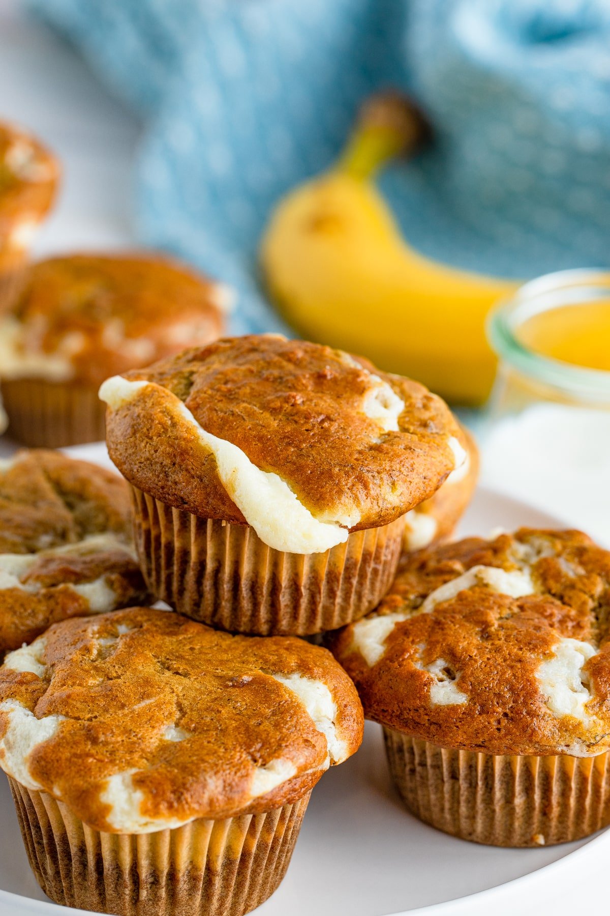 cream cheese muffins stacked on a white plate