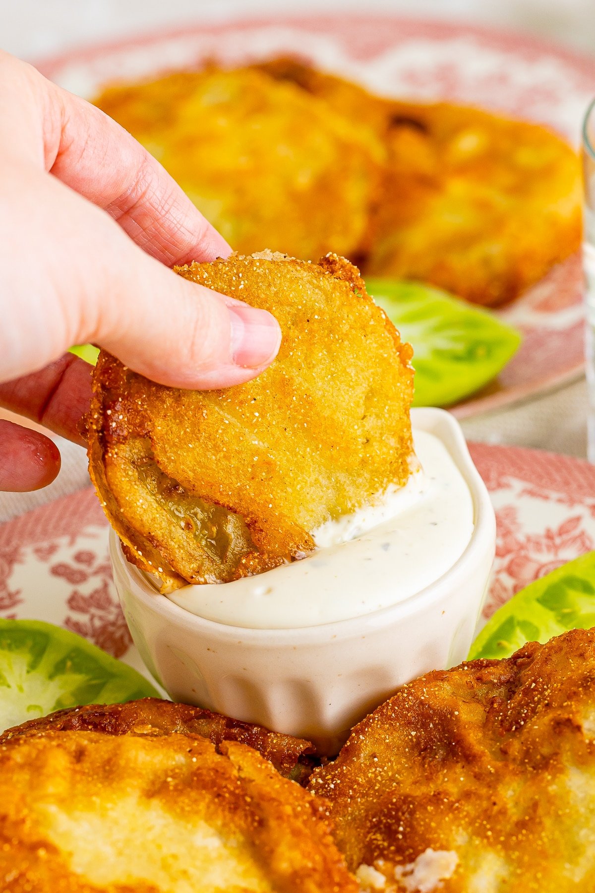 easy fried green tomatoes recipe being dipped in ranch