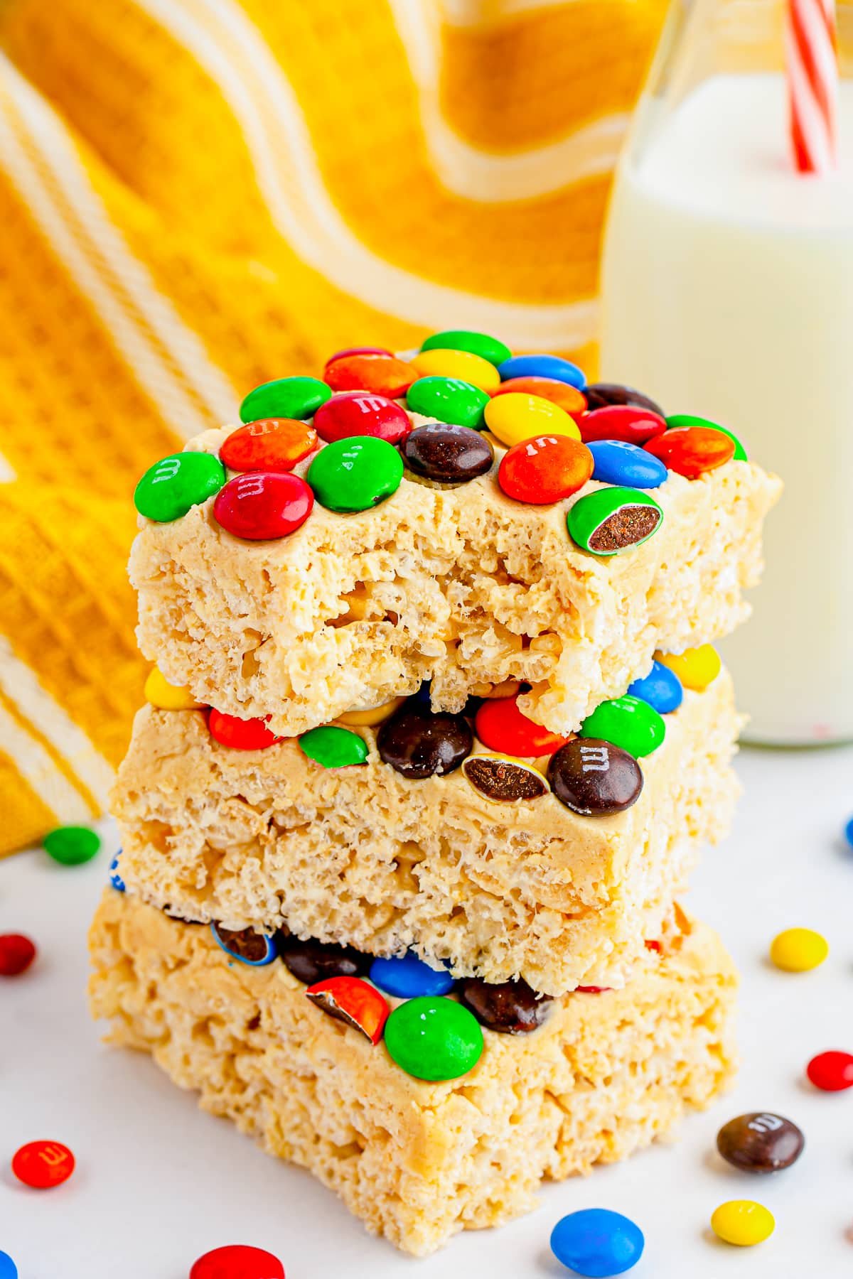 M&M rice krispie treats stacked with a bite taken out