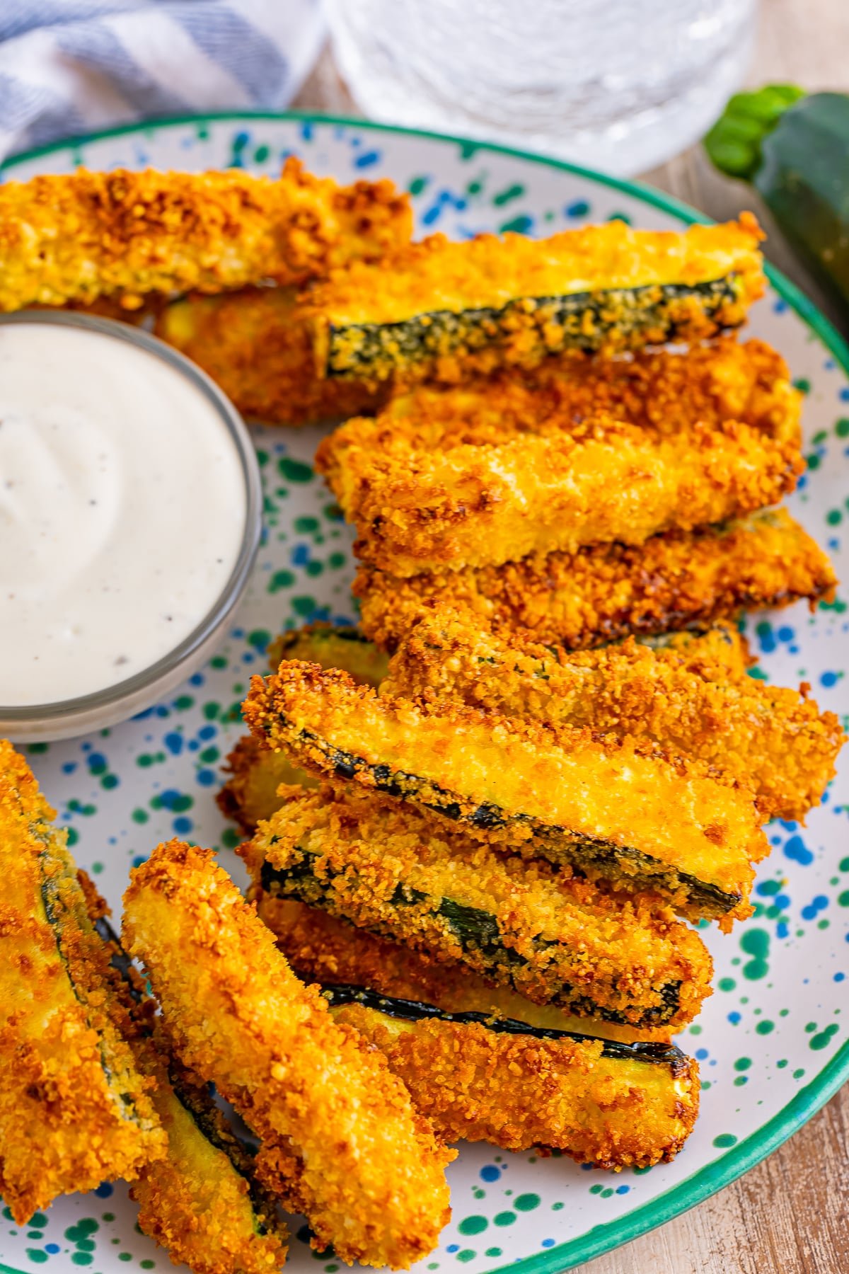 air fryer zucchini fries on a speckled plate