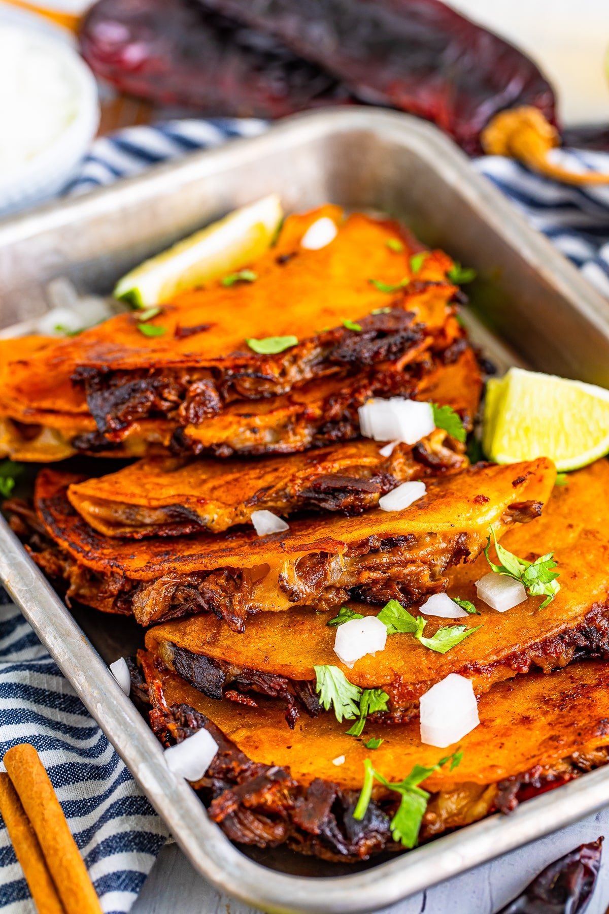birria de res recipe made into tacos on a silver platter