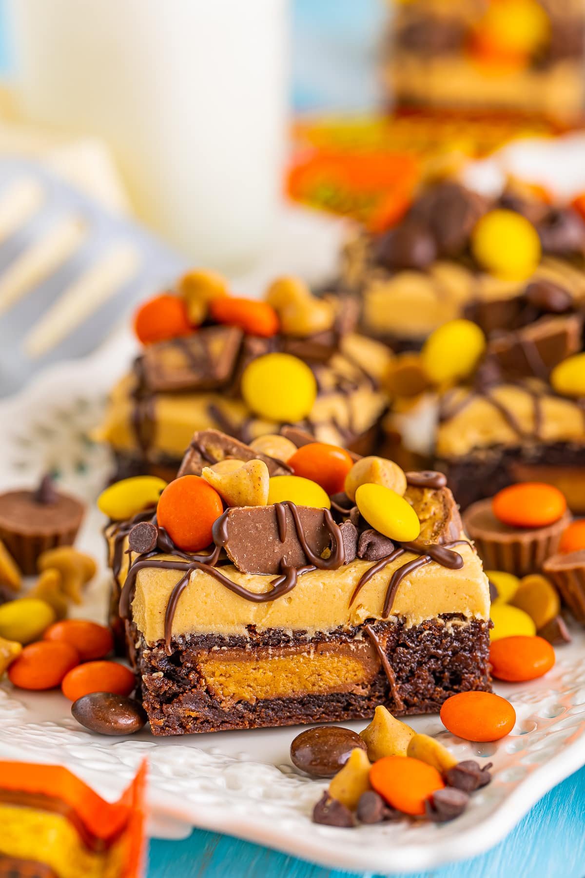 chocolate peanut butter brownies on a white serving plate