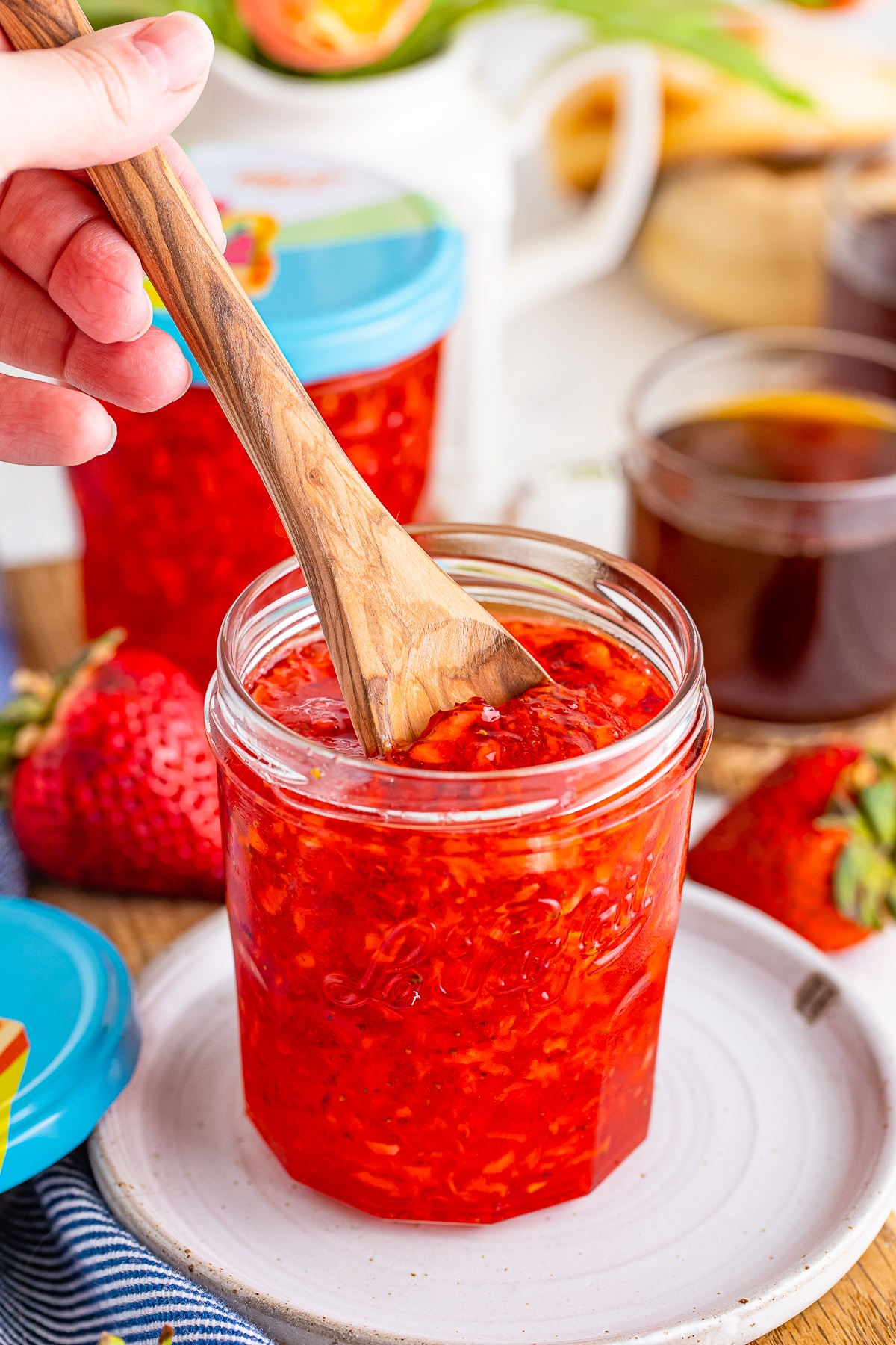 a spoon dipping into strawberry freezer jam