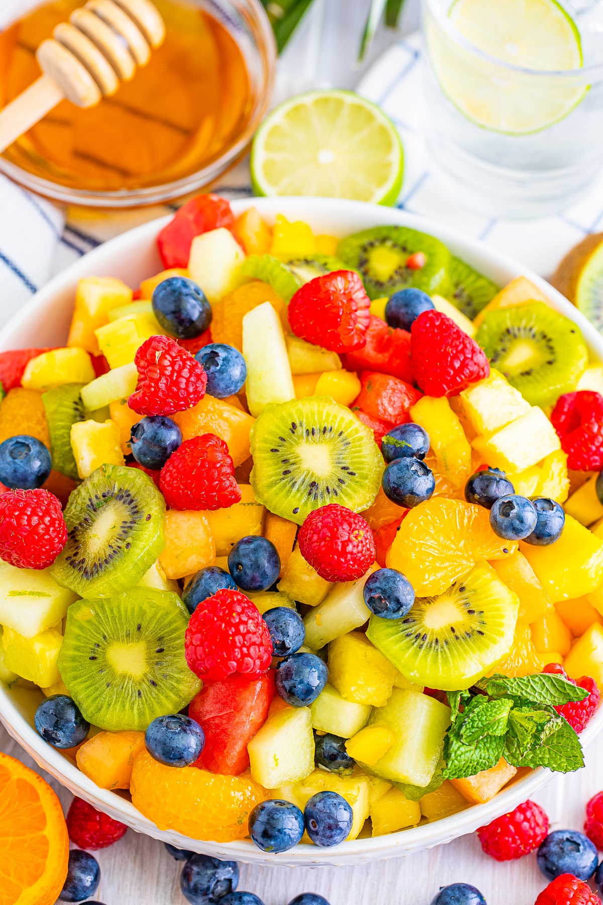 overhead image tropical fruit salad in a white bowl