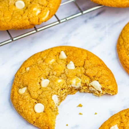 A plate of soft white chocolate chip cookies loaded with creamy white chocolate chips.