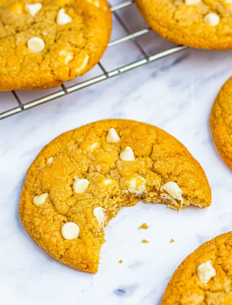 A plate of soft white chocolate chip cookies loaded with creamy white chocolate chips.