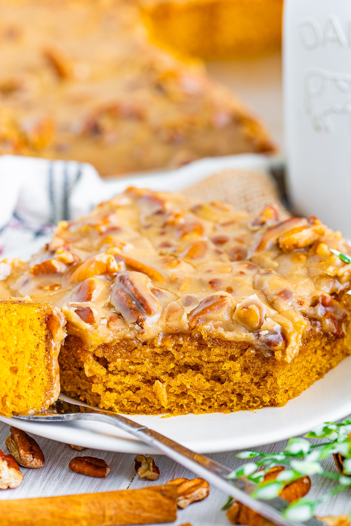 close up of pumpkin sheet cake with a bite taken out