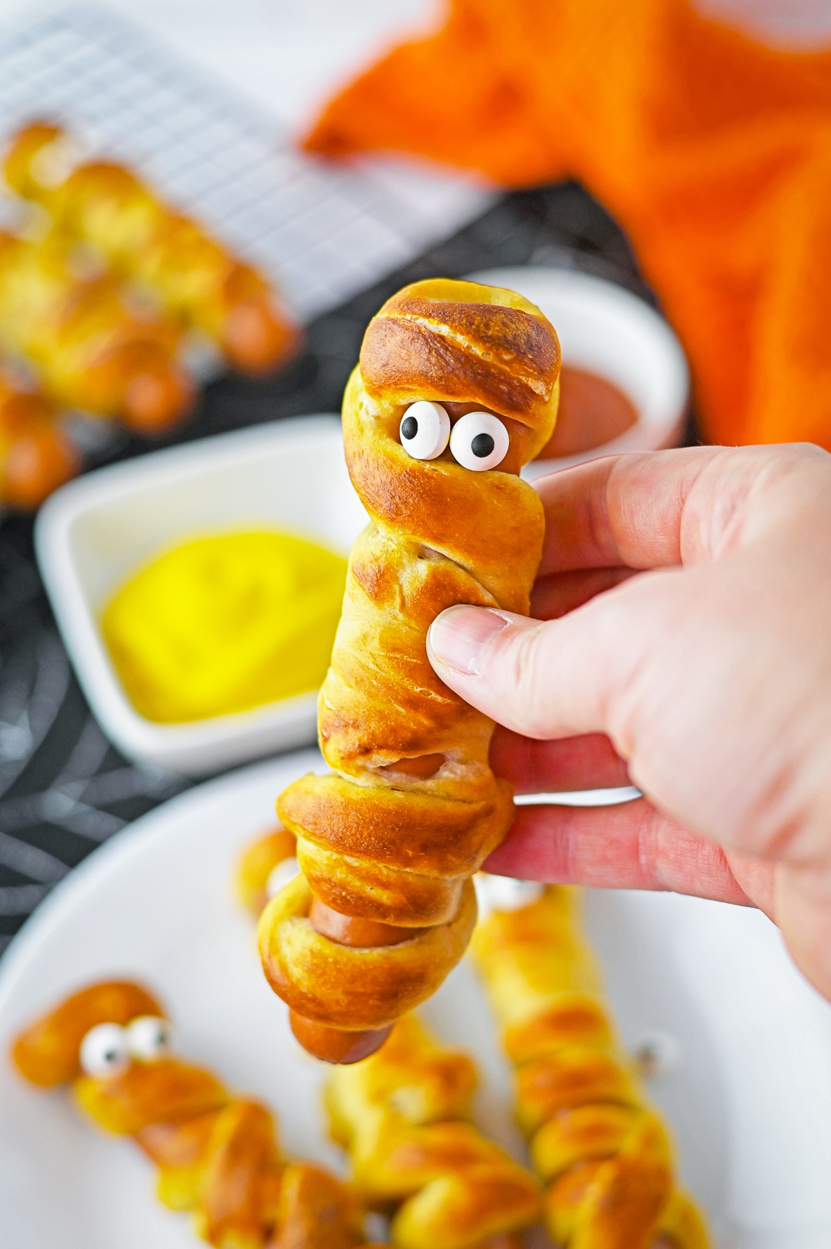 a pretzel dogs being held in air