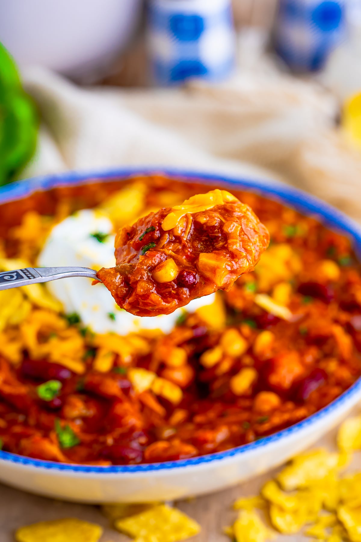 a spoon holding up a bite of turkey chili recipe in air 