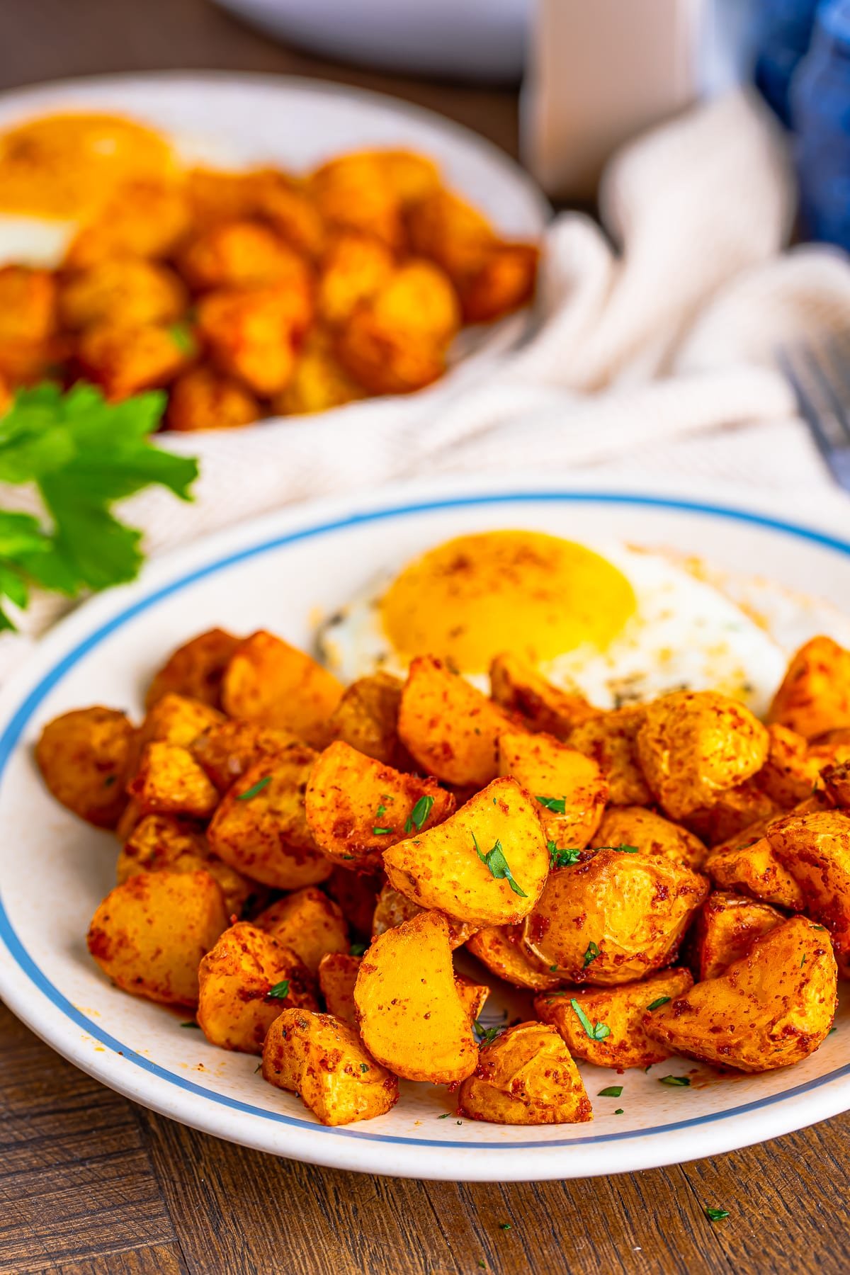 air fryer home fries on a plate with egg