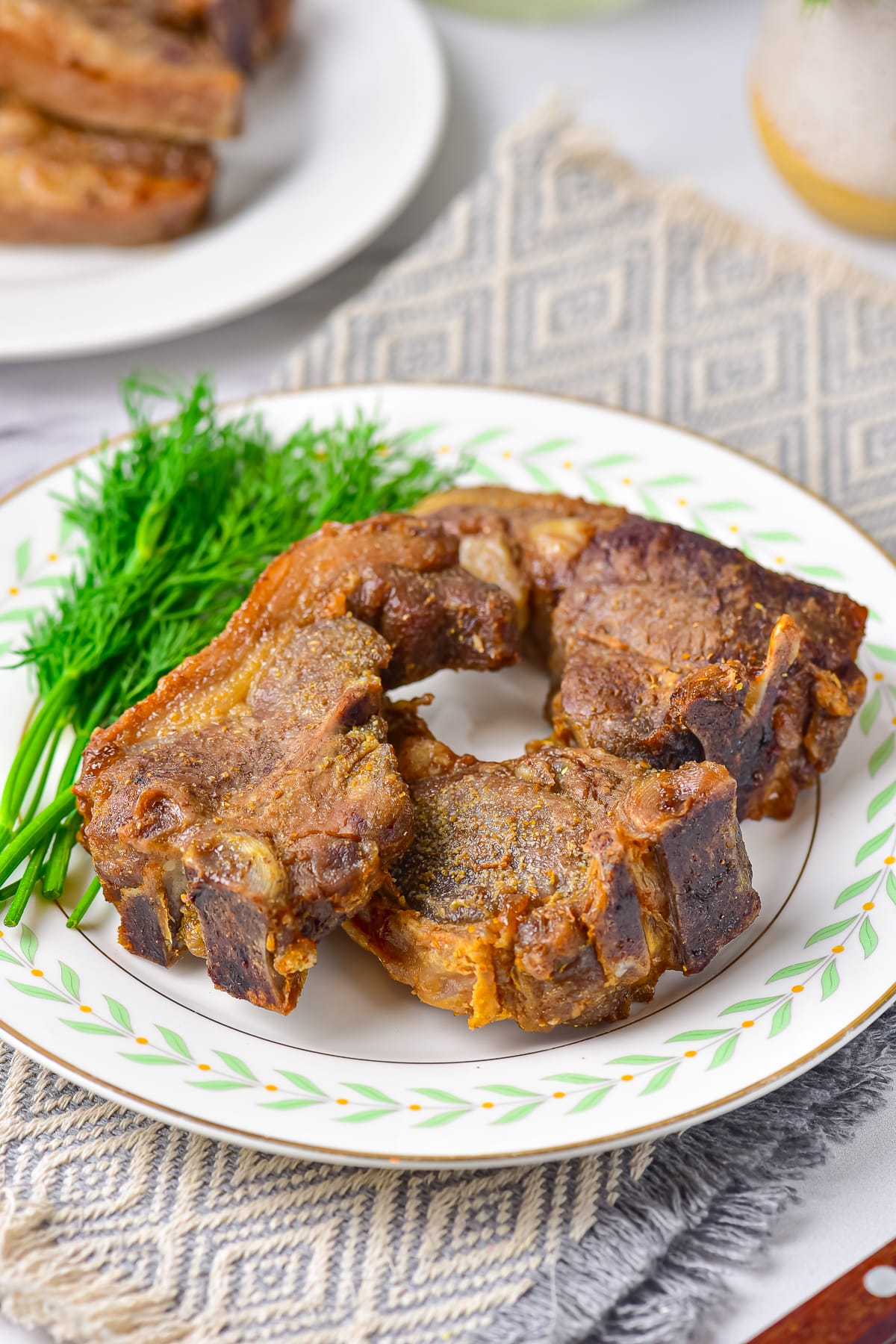 air fryer lamb chops on a plate with dill