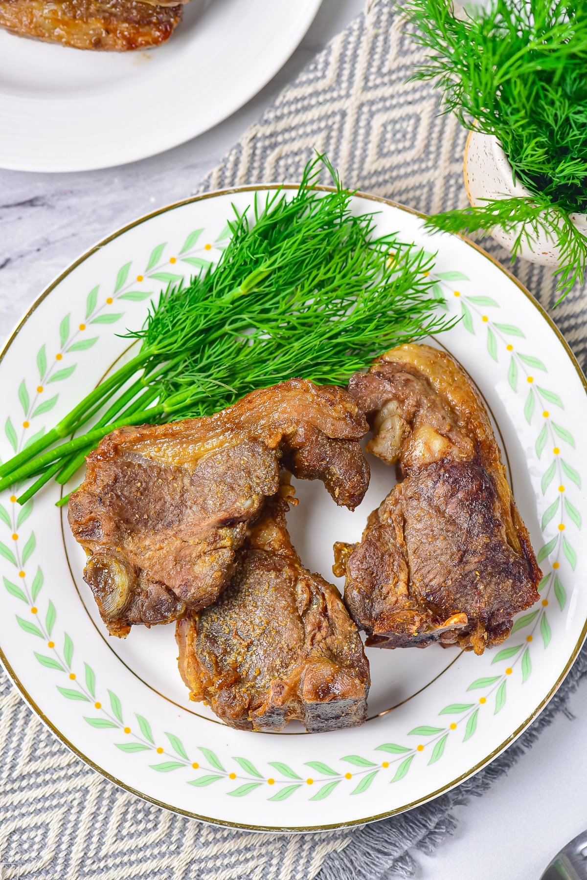 overhead image air fryer lamb chops on a plate