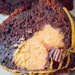 A slice of brownie cake showing the fudgy chocolate cake and creamy peanut butter filling inside.
