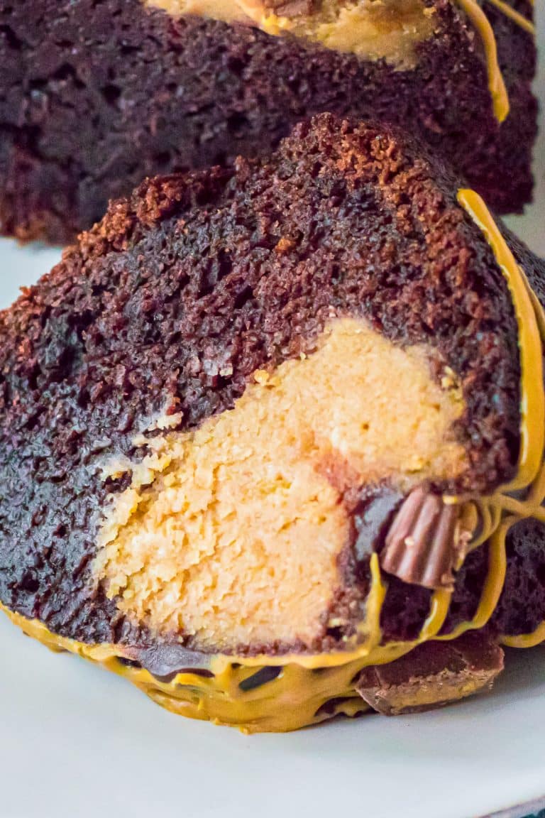 A slice of brownie cake showing the fudgy chocolate cake and creamy peanut butter filling inside.