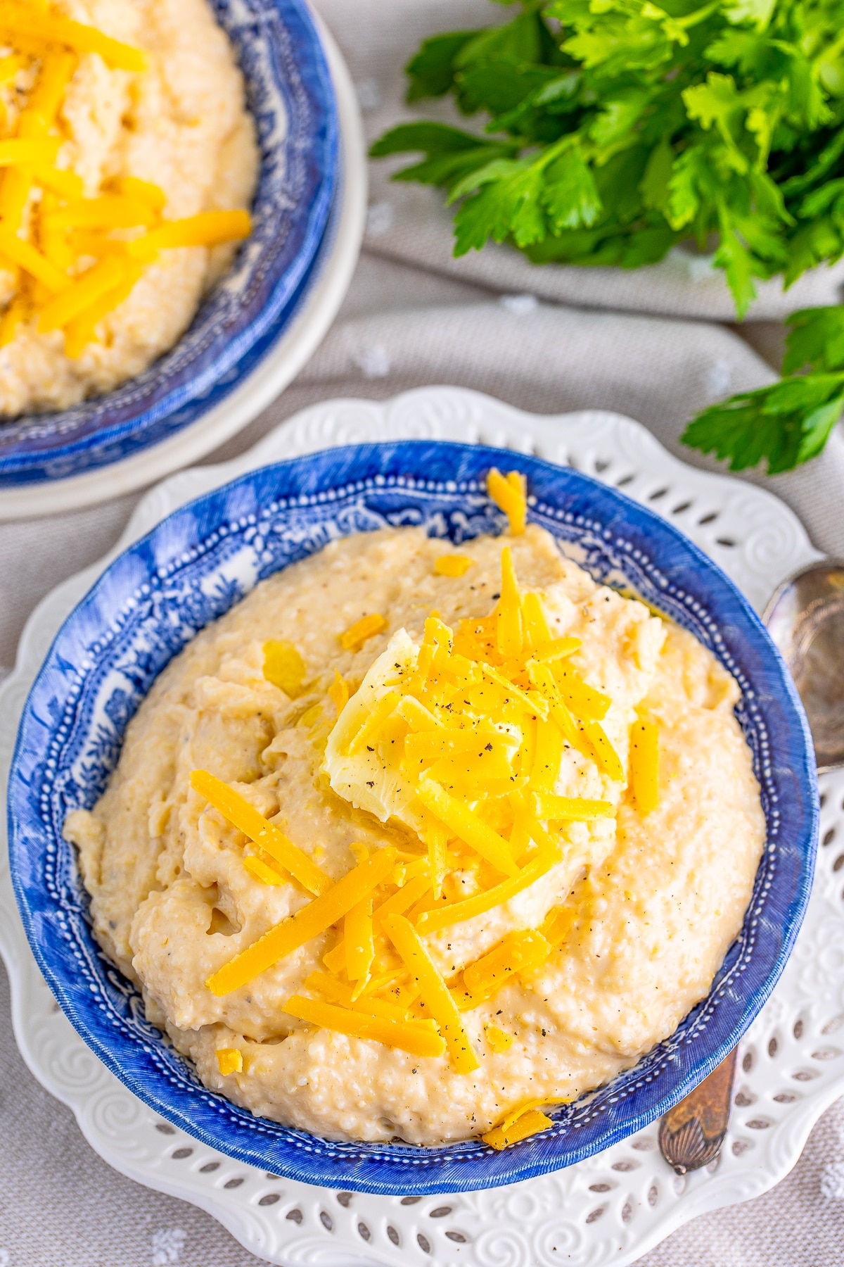 overhead cheesy grits in blue serving bowl