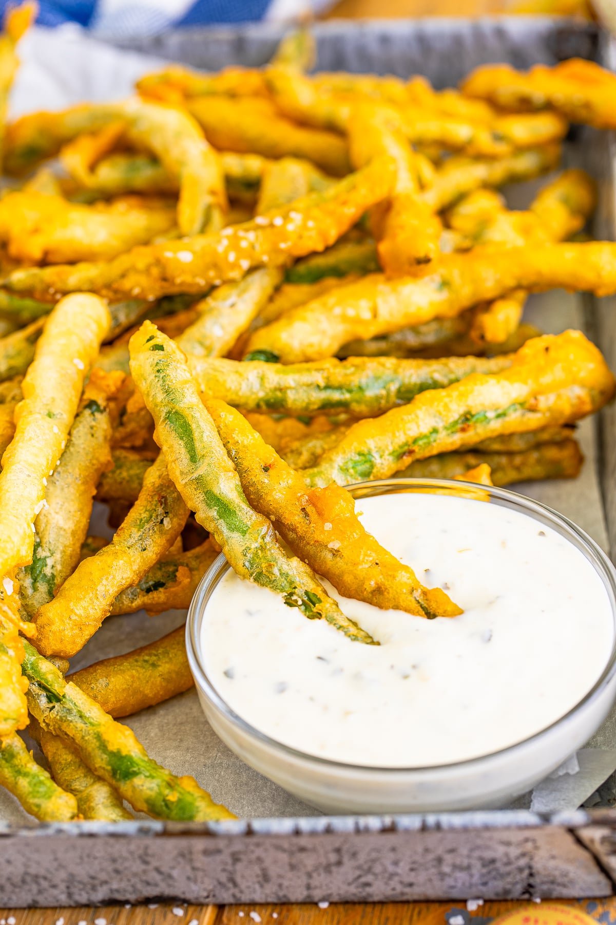 fried green beans recipe on serving platter in ranch