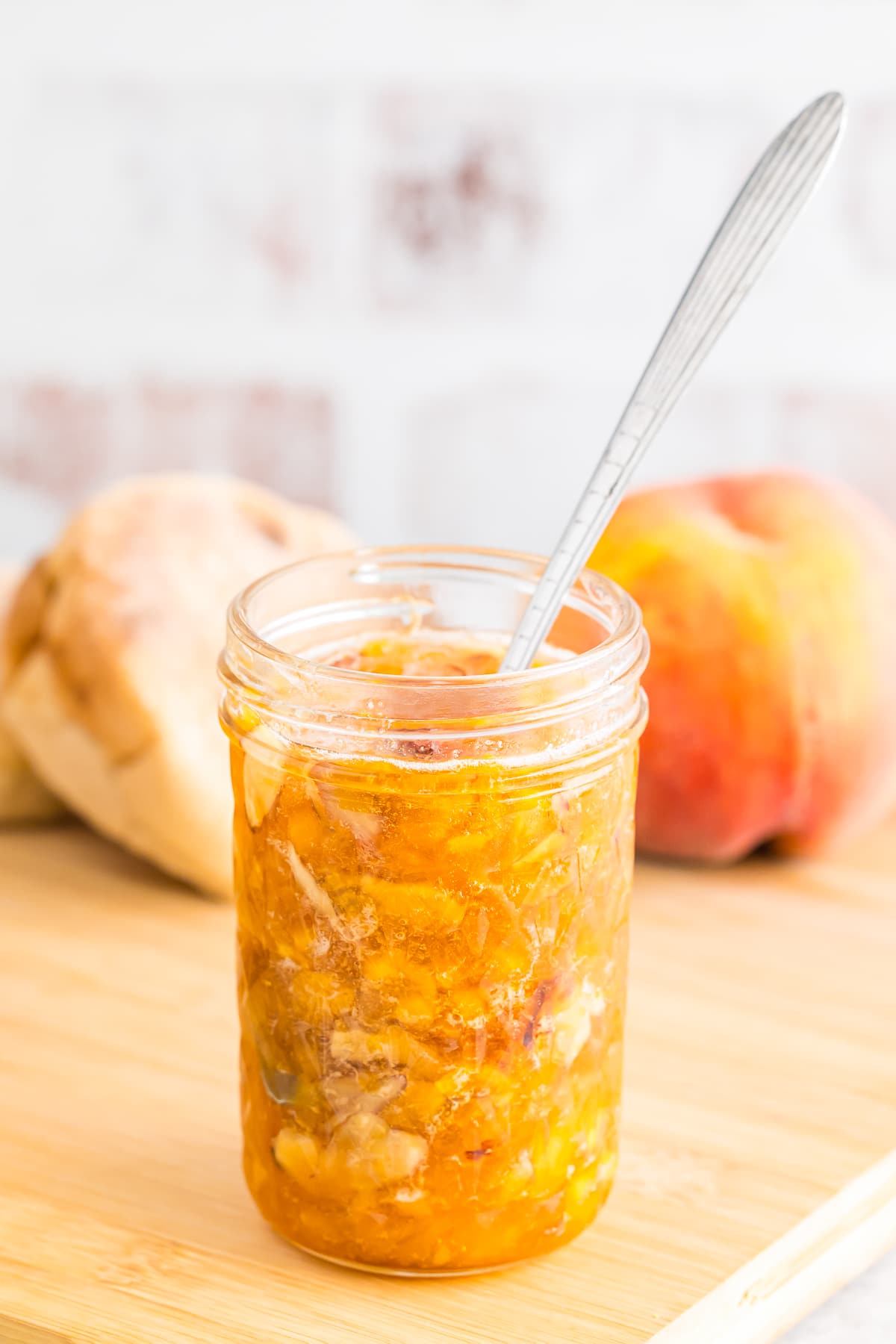 peach jam in mason jar with spoon