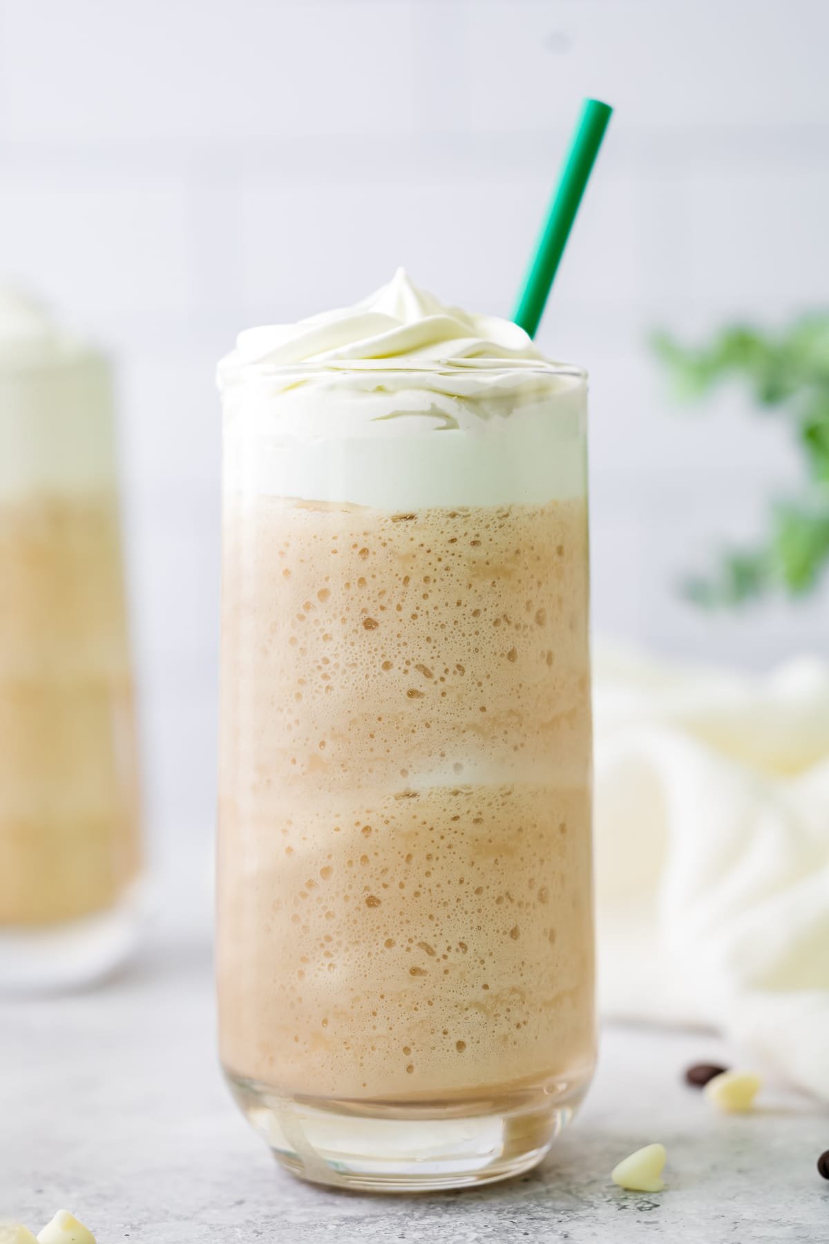white chocolate mocha in a glass with green straw