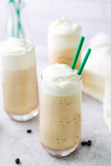 White chocolate mocha frappuccino in a tall glass topped with whipped cream.