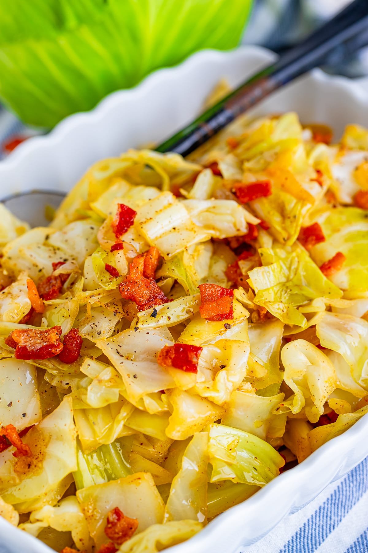 fried cabbage with bacon in a white bowl