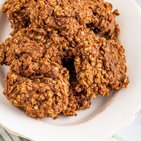 A plate piled with No Bake Cookies, chocolate peanut butter oatmeal cookies.