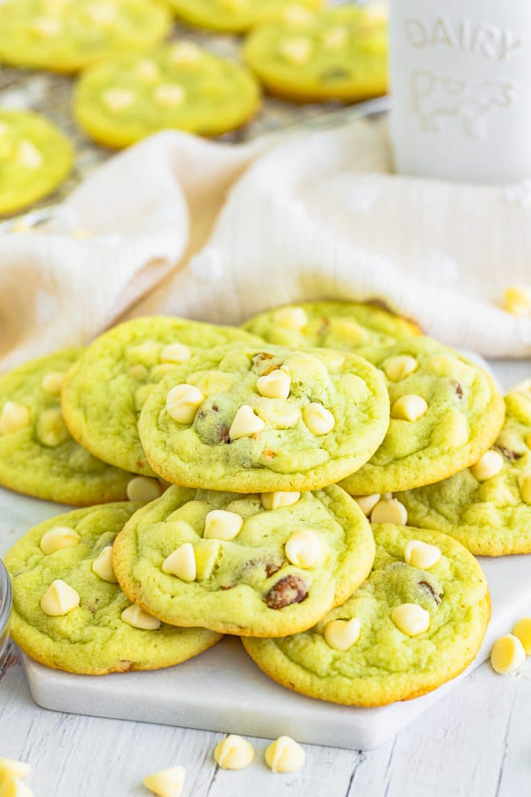 A stack of soft pistachio pudding cookies studded with white chocolate chips and pistachios.