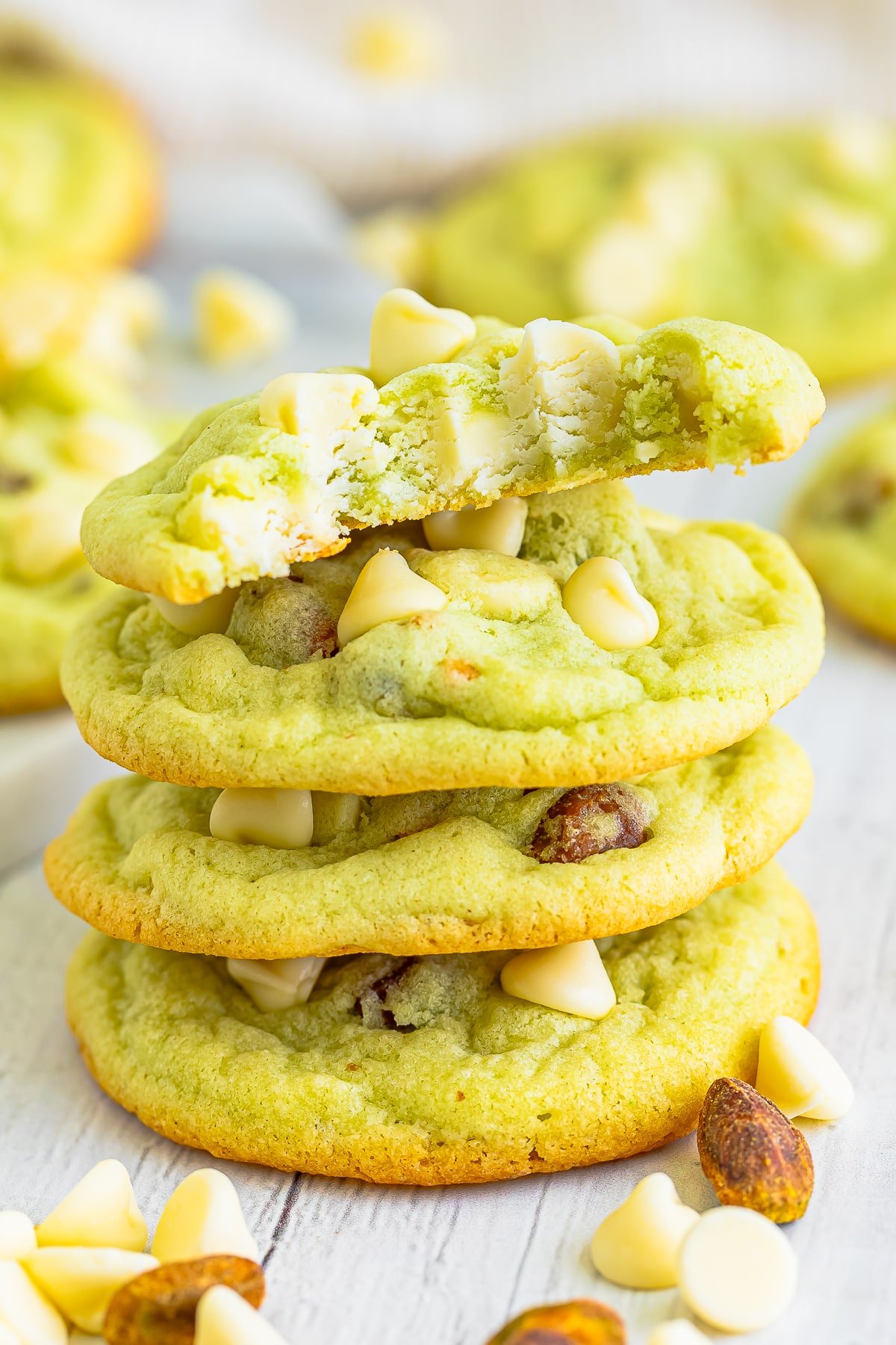 a stack of pistachio cookies with a bite taken out