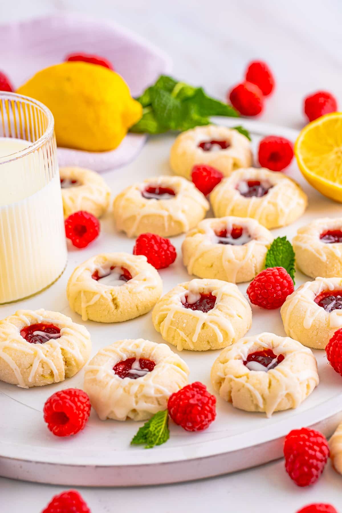 raspberry thumbprint cookies on a white platter