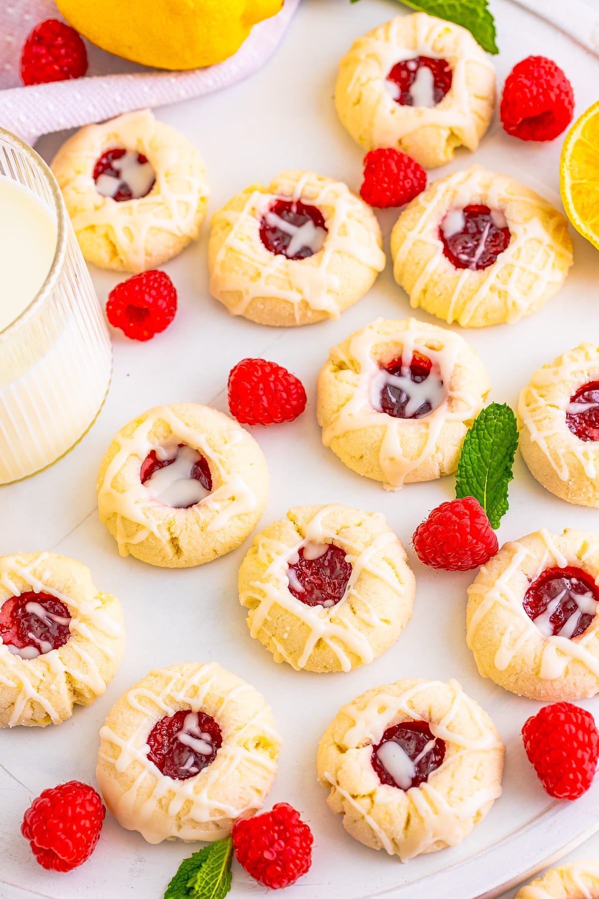 raspberry thumbprint cookies on white platter
