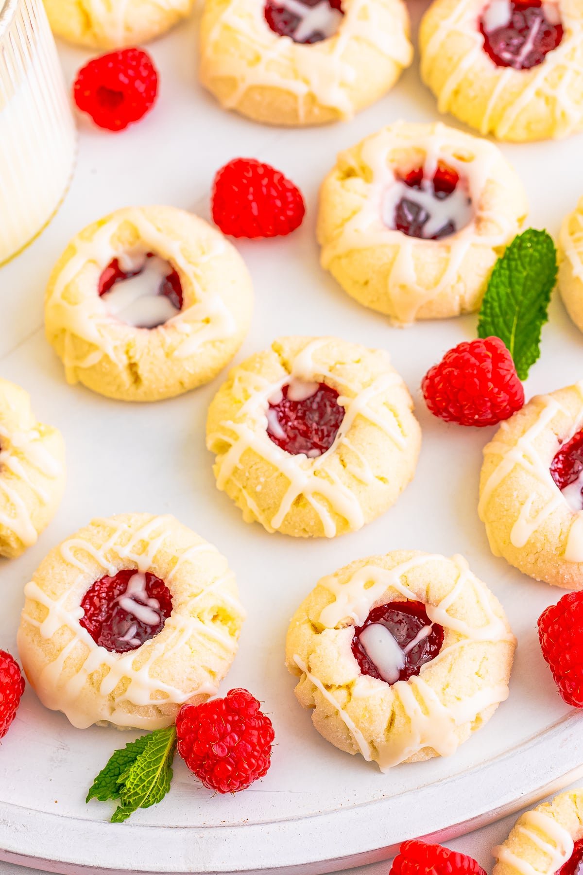 raspberry thumbprint cookies on a white platter