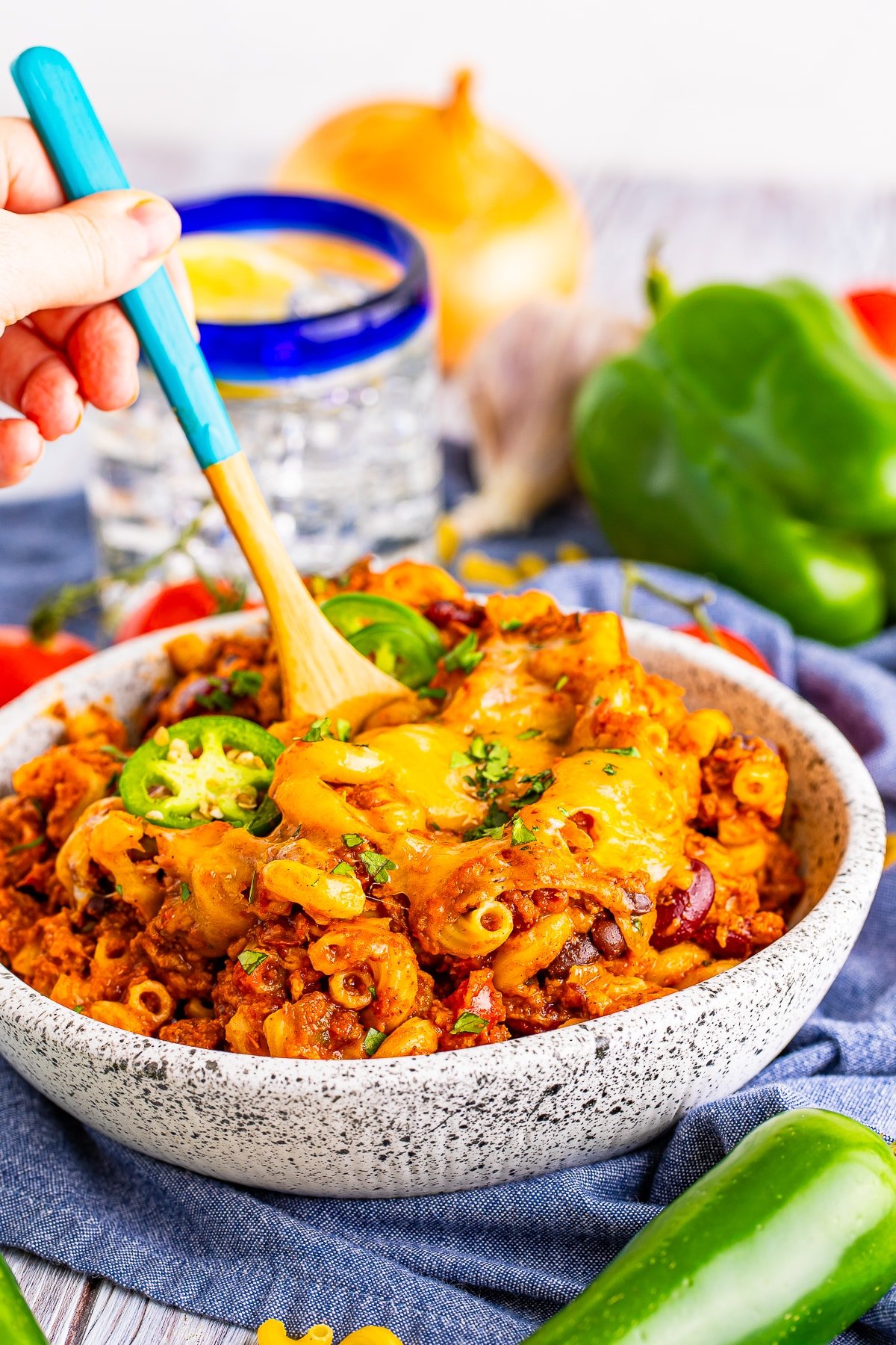 a spoon in a bowl of chili mac and cheese recipe