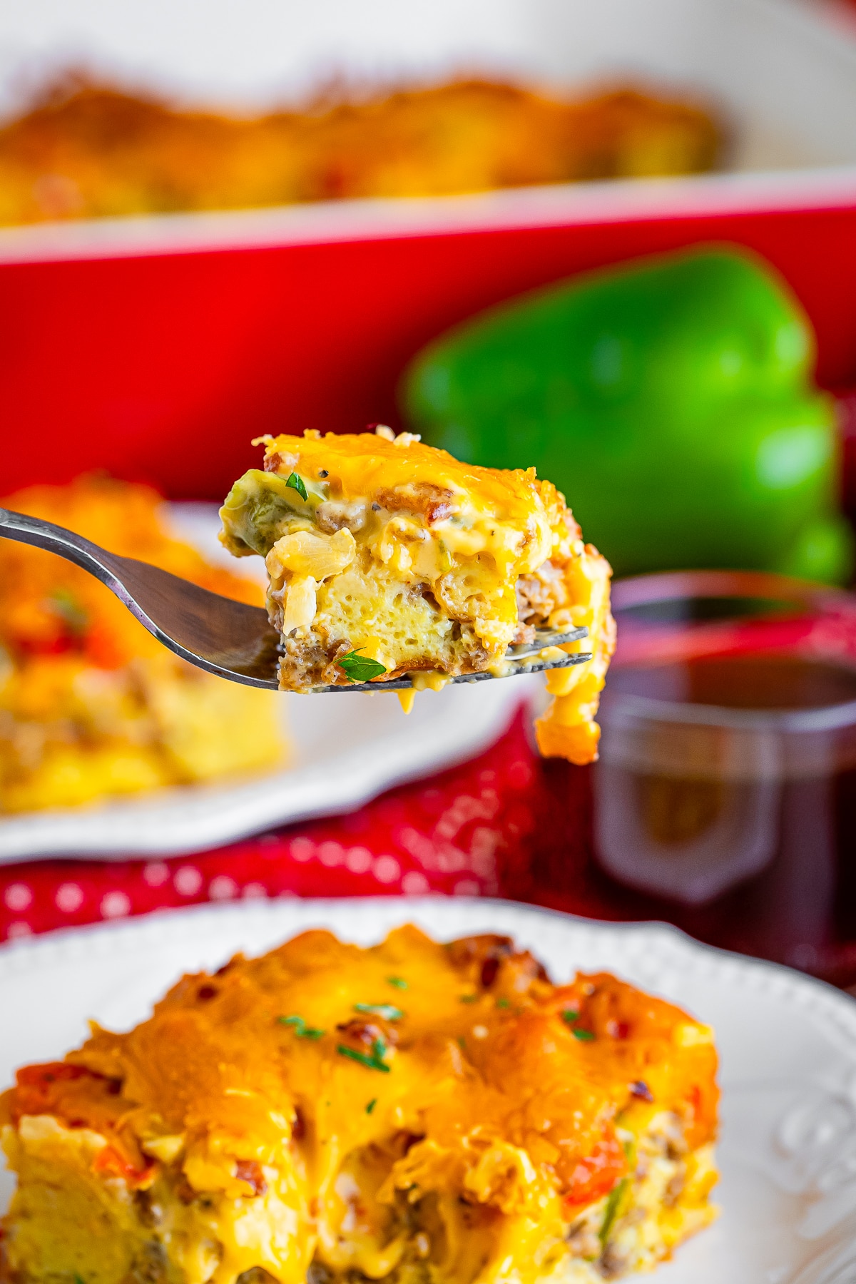 a bite of christmas breakfast casserole on a fork in air