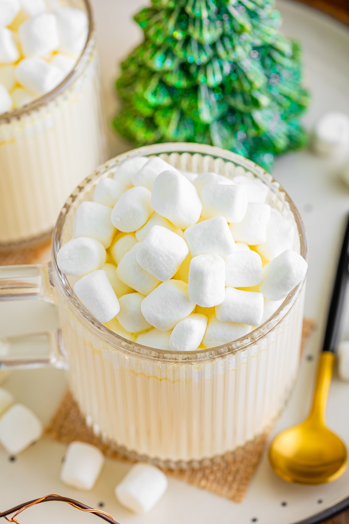 overhead image white hot chocolate in glass mug with marshmallows