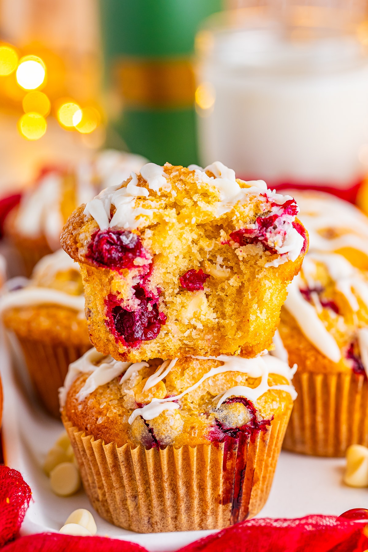 orange cranberry muffins stacked with a bite taken out