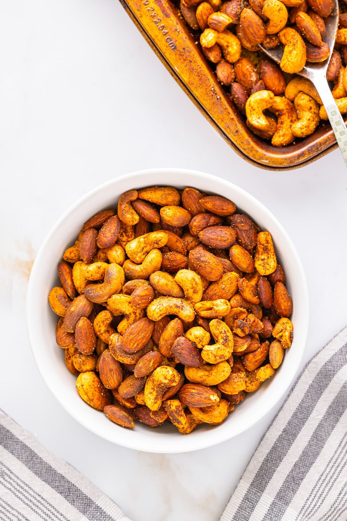overhead image roasted nuts in a white bowl