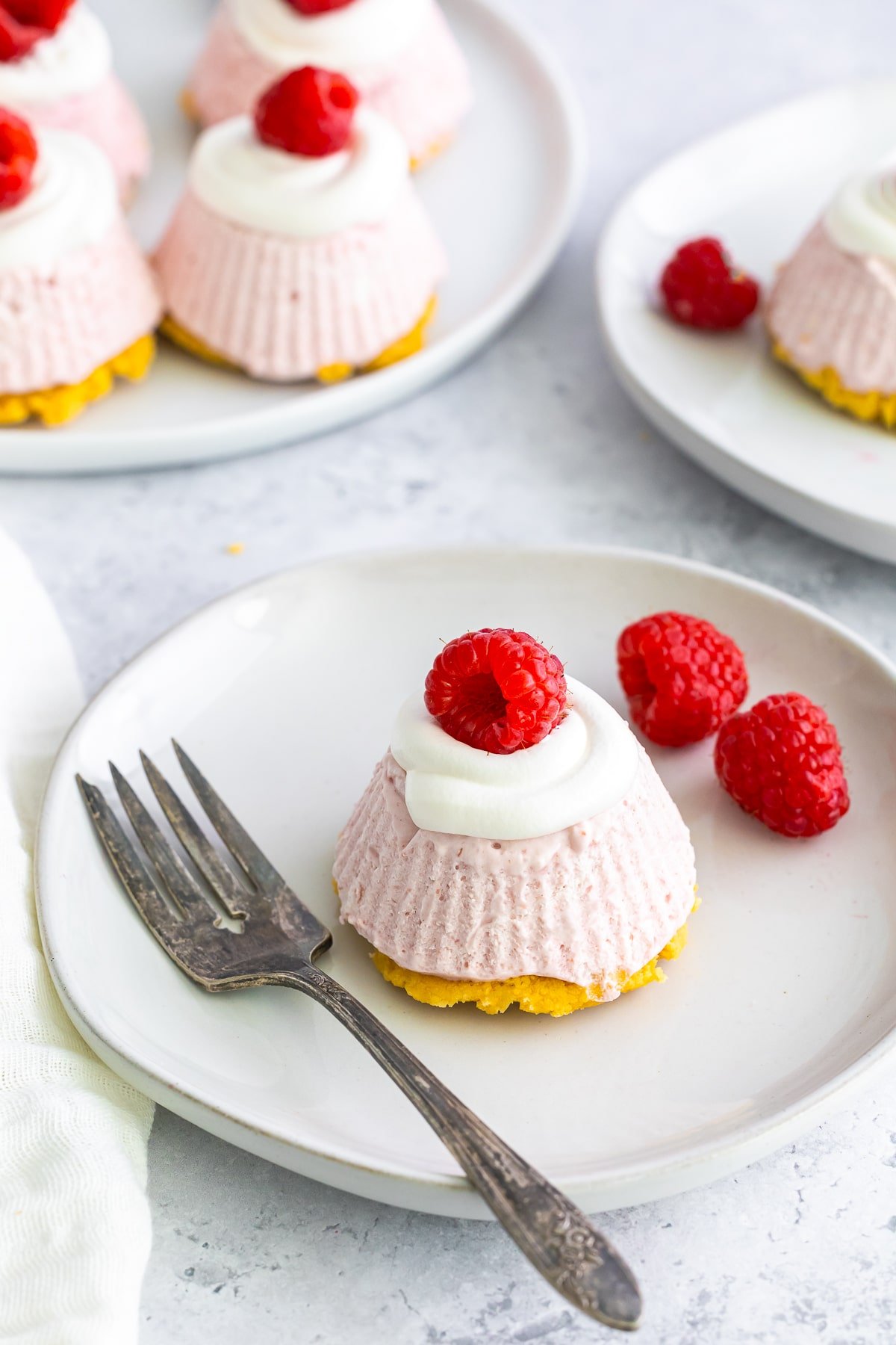 no bake oreo cheesecake with raspberries on a white plate