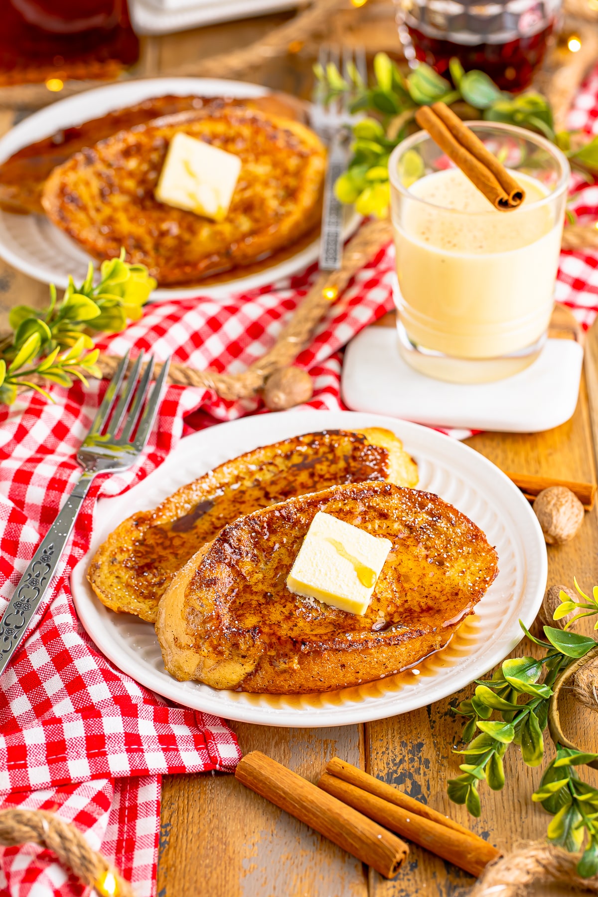 a table set with eggnog french toast on plates