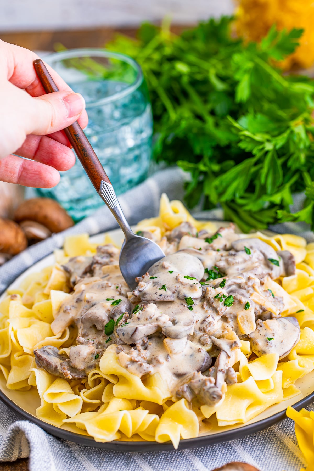 a fork digging into ground beef stroganoff recipe