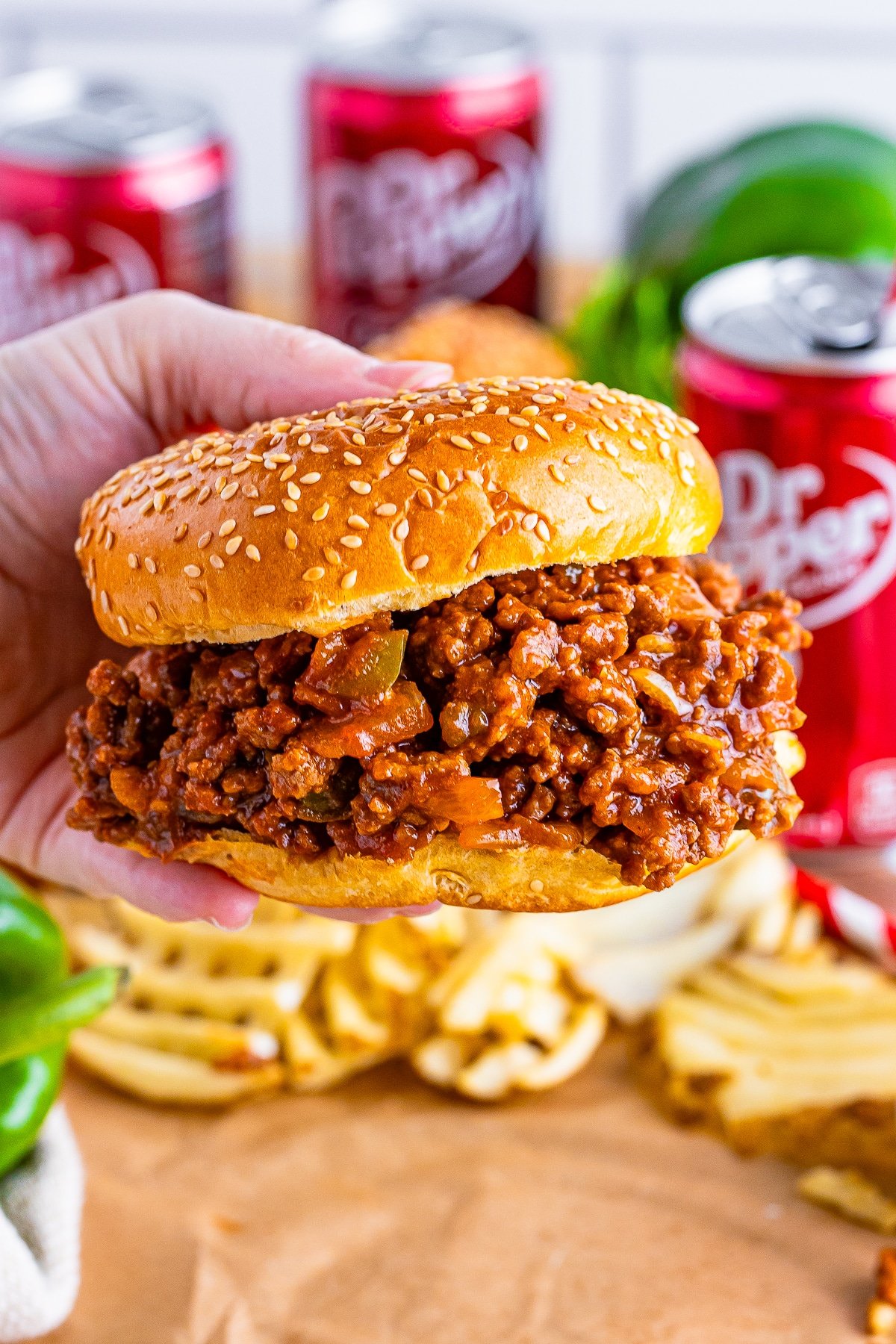 a hand holding up sloppy joes recipe in air