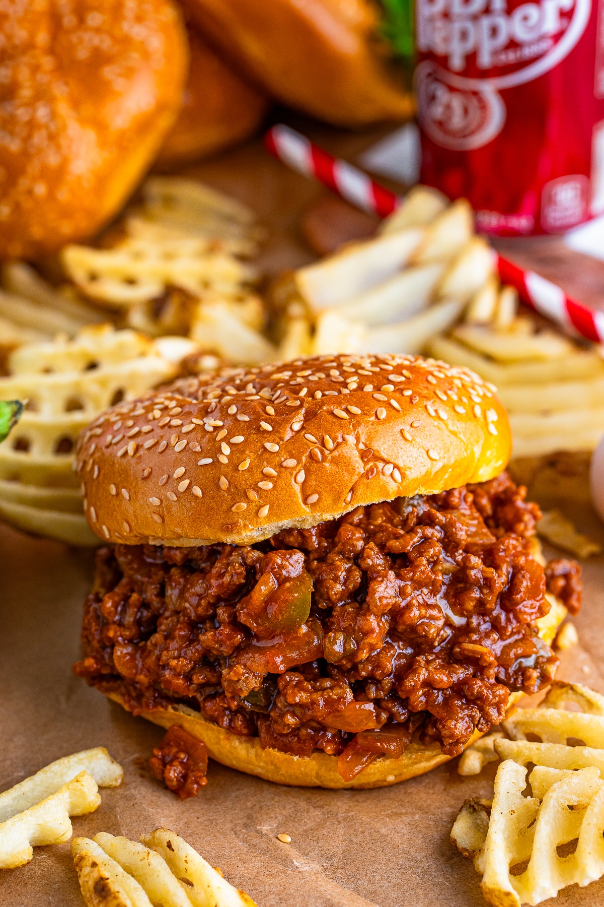 sloppy joes recipe on parchment paper surrounded by fries